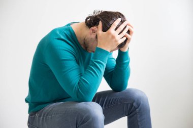 Depressed man on studio background