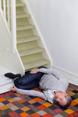 Elderly man who has fallen down stairs.
