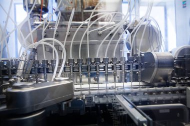 Pharmaceutical industry, automatic filling of injectable syringes (pre-filled syringes) in a sterile environment.