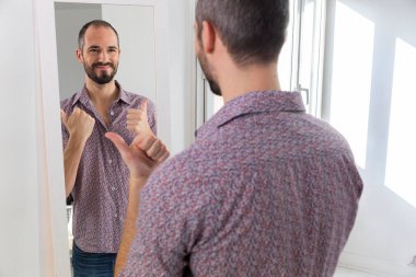 A man looking in a mirror to give him self-confidence.