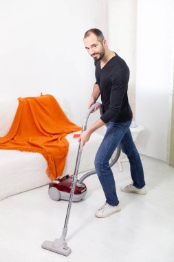 A man vacuuming at home