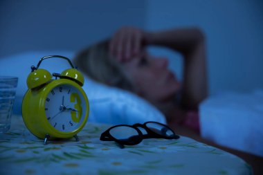 Woman struggling to wake up in the morning.