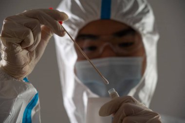 Medical personnel performing an antigen test for covid-19.