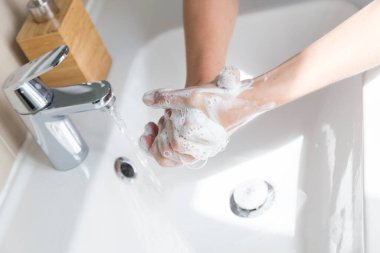 A woman suffering from contamination OCD: obsessive hand washing.