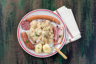 Choucroute garnie, a typical alsacian plate, with sausages, bacon, sauerkraut and potatoes