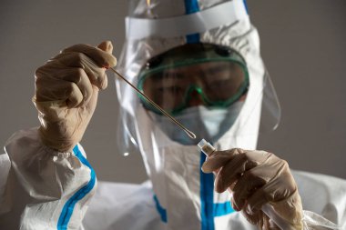 Medical personnel performing an antigen test for covid-19.