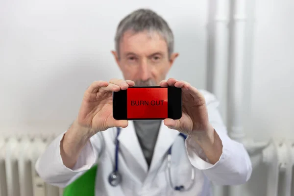 Doctor Holding Screen Burn Out Written — Photo