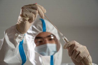 Medical personnel performing an antigen test for covid-19.