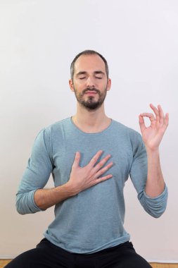 A man carrying out relaxation techniques.