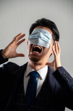 Screaming man wearing a mask over his eyes