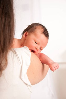 2-week-old baby in mother's arms.