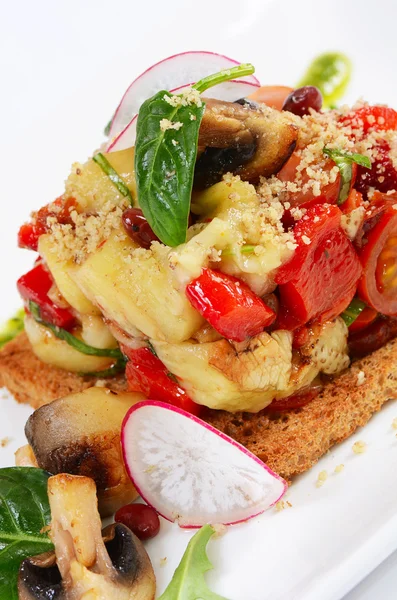 Salad from baked eggplants and peppers with mushrooms grilled bread — Stock Photo, Image