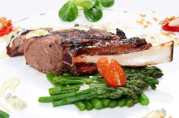 Rack of lamb on grill with an asparagus — Stock Photo, Image