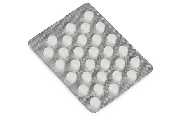 Tabletas en embalaje aisladas en blanco —  Fotos de Stock