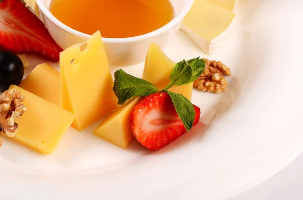 Assorted cheese with honey — Stock Photo, Image