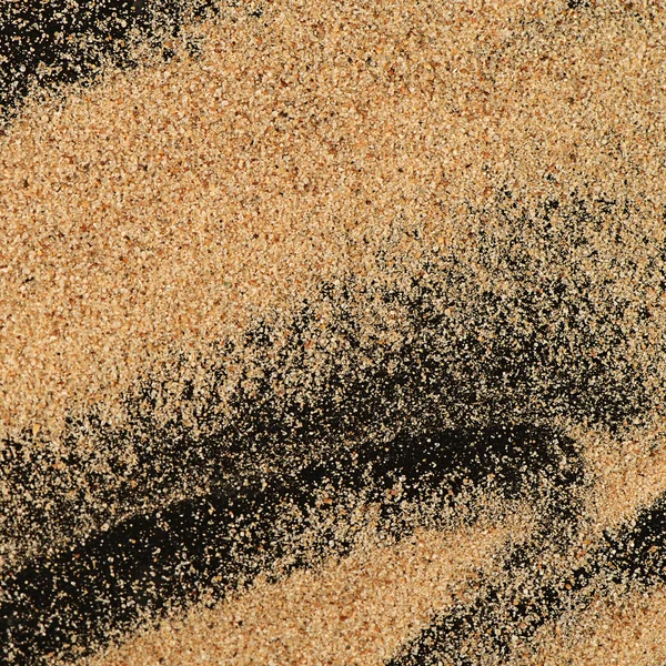 Песок на черном фоне — стоковое фото