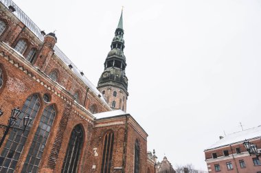 Winter cityscape of Old town of Riga, Latvia. Snow on roof of St. Peter's Church.