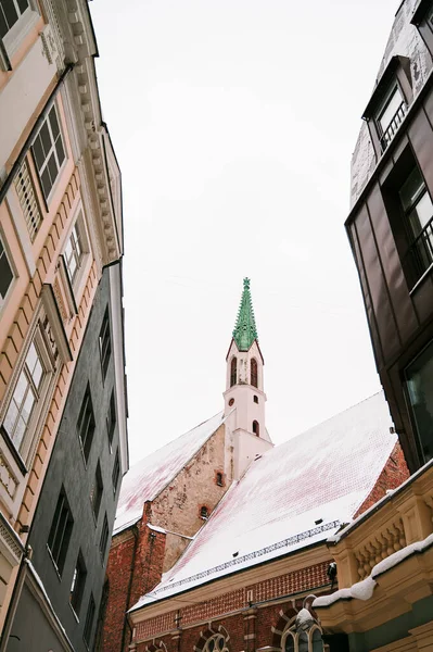 Snow on the roof of Catholic Church in the old town of Riga. Winter cityscape.