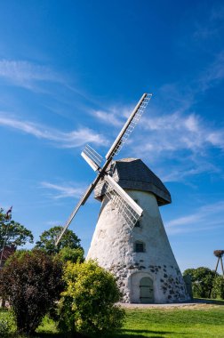 Dutch-type windmill in Araisi, Latvia. Sunny summer day. Old Europe style. Blue sky. Green grass.
