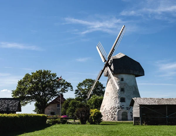 Dutch-type windmill in Araisi, Latvia. Sunny summer day. Old Europe style. Blue sky. Green grass.
