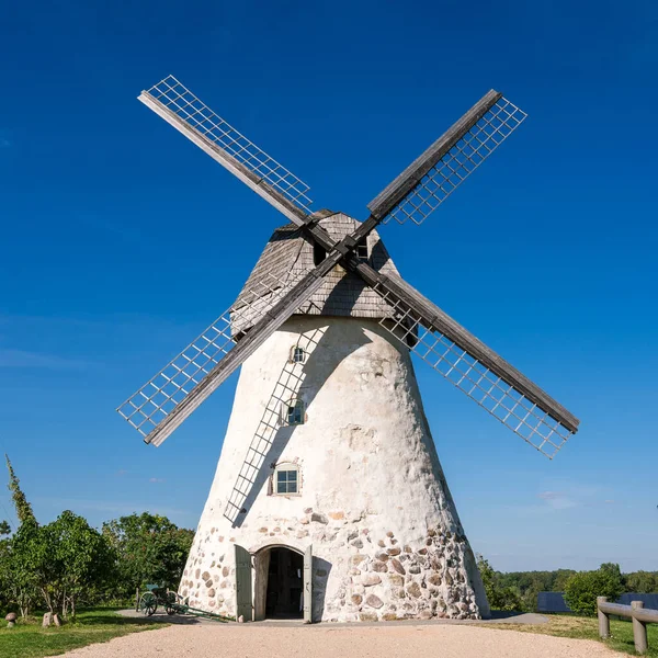 Dutch-type windmill in Araisi, Latvia. Sunny summer day. Old Europe style. Blue sky. Green grass.