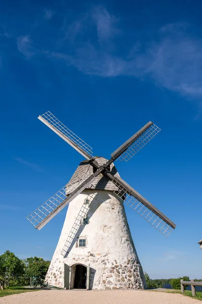 Dutch-type windmill in Araisi, Latvia. Sunny summer day. Old Europe style. Blue sky. Green grass.
