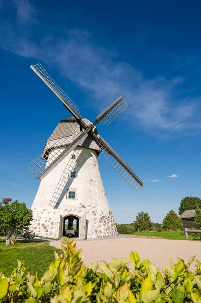 Dutch-type windmill in Araisi, Latvia. Sunny summer day. Old Europe style. Blue sky. Green grass.