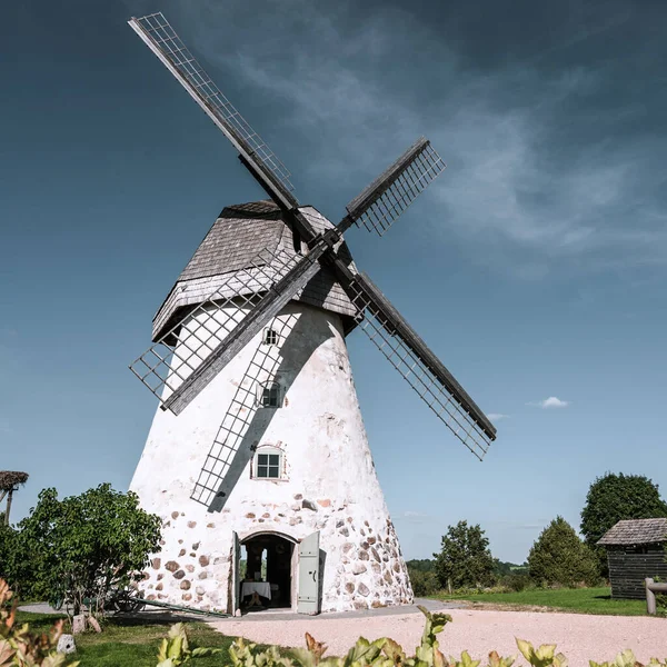 Dutch-type windmill in Araisi, Latvia. Sunny summer day. Old Europe style. Blue sky. Green grass.