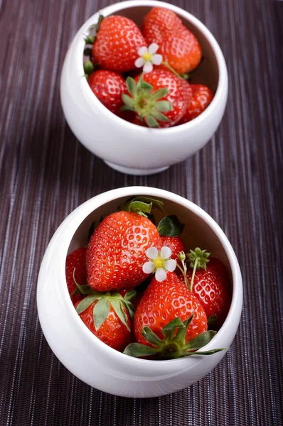Strawberries in a two small white bowls — Stock Photo, Image