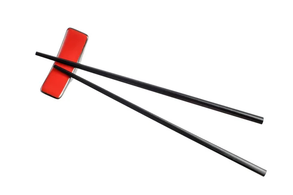 红色架子上的黑色木制筷子 白色背景隔离 — 图库照片