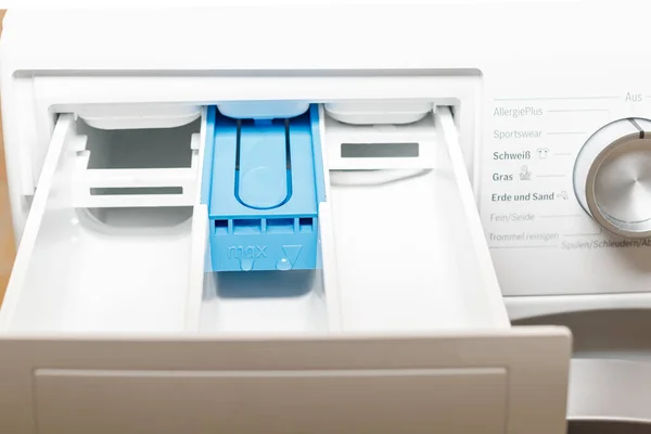Opened tray of washing machine after cleaning with water. Hygiene service for home equipment