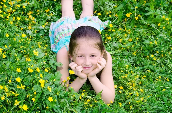 The girl lies on a glade with flowers — Stock Photo, Image