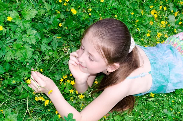 The child has a rest on a glade with flowers — Stock Photo, Image