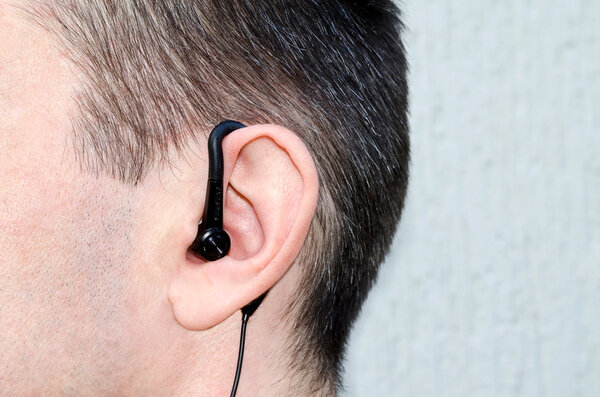 the earphone in an ear of the man
