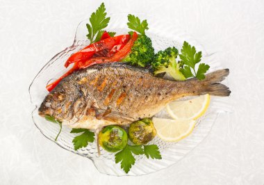 Dorado fish garnished with vegetables, clipart
