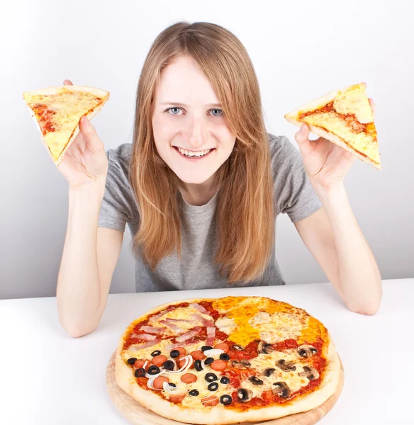 Young girl holding two slices of pizza — Stock Photo, Image