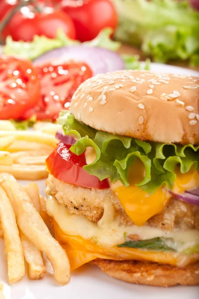 Cheeseburger with fries and ingredients — Stock Photo, Image