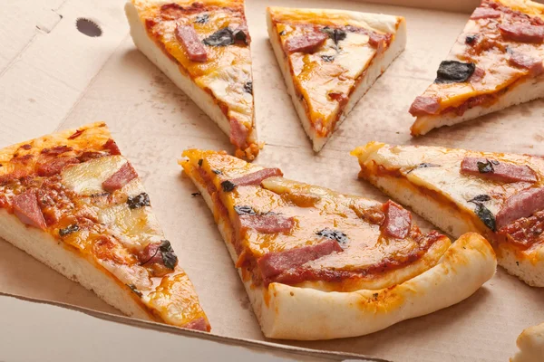 Slices of ham and cheese pizza in a box — Stock Photo, Image