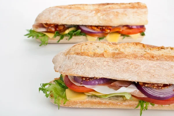 Two halves of long white wheat baguette sandwich — Stock Photo, Image