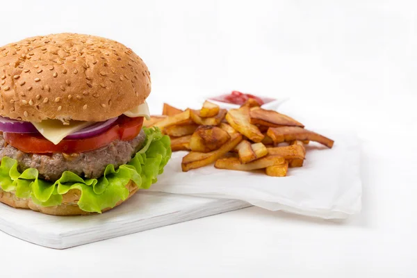 Hamburger with fries and sauce — Stock Photo, Image