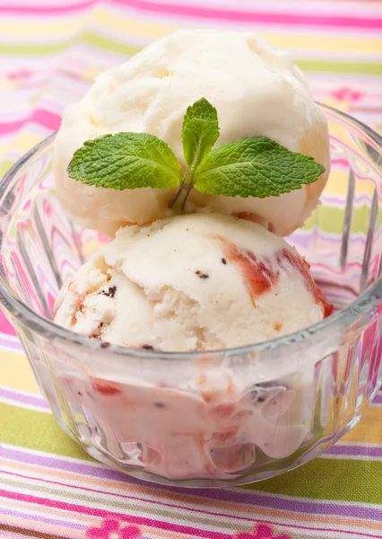 Scoops of ice cream with mint leaves in a glass — Stock Photo, Image