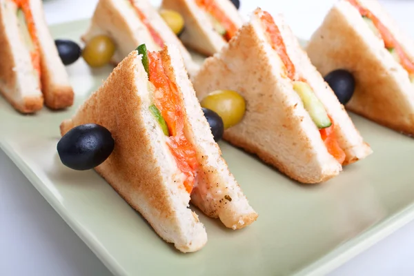 Club sandwiches with salmon and cucumbers — Stock Photo, Image