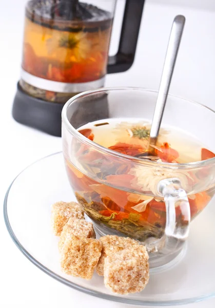 Green tea with flowers in a glass cup — Stock Photo, Image