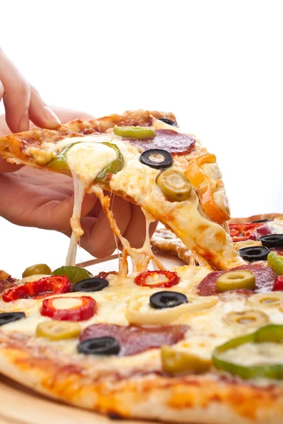 Slice of pizza in the hand — Stock Photo, Image