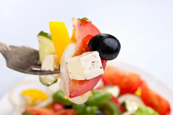 Greek salad on a fork — Stock Photo, Image