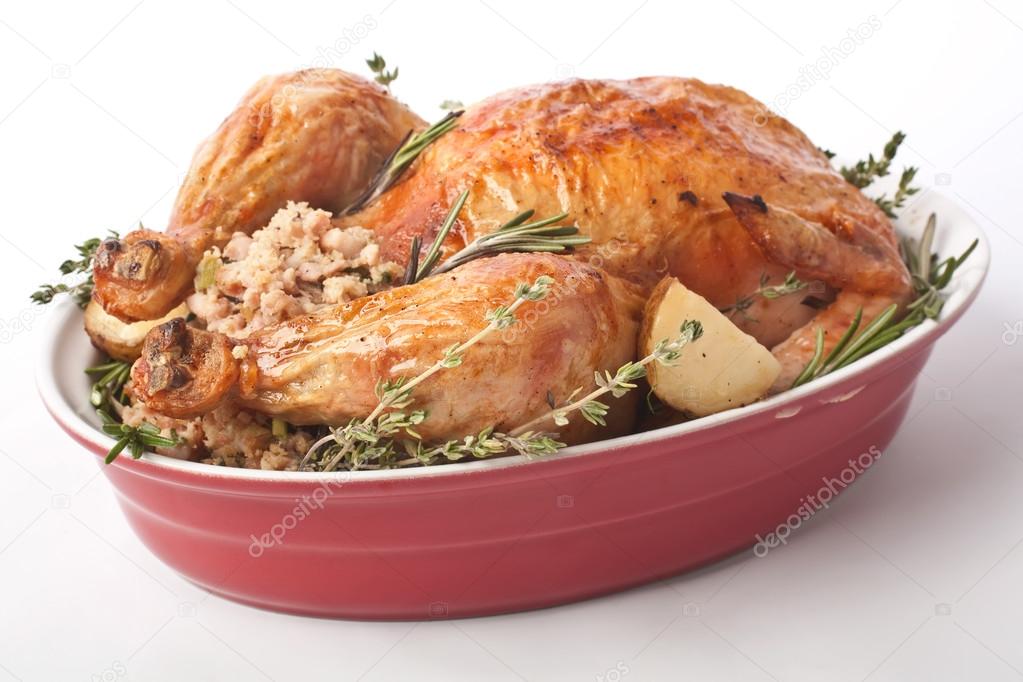 whole roasted stuffed turkey in a dish