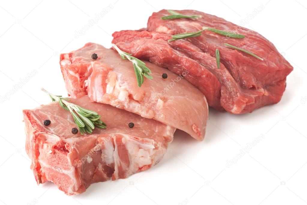 Raw pork chops and beef medallions