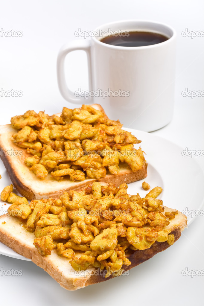 scrambled eggs on toasts and coffee breakfast