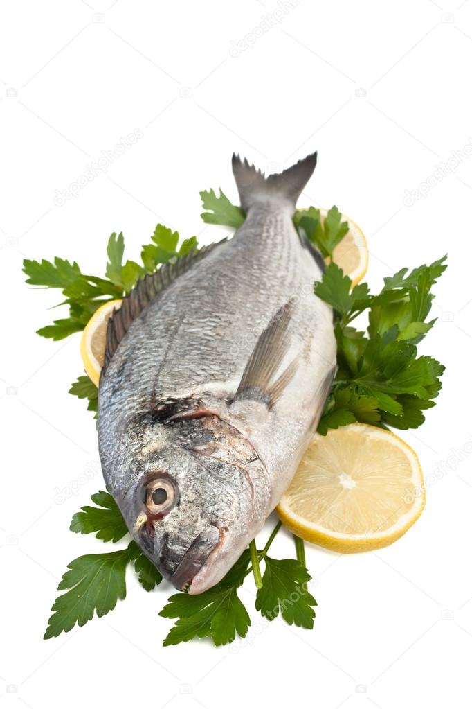 raw dorado fish with hebs and lemon