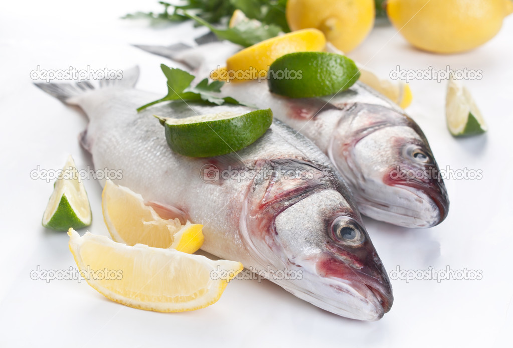 raw seabas fish with hebs, limes and lemons